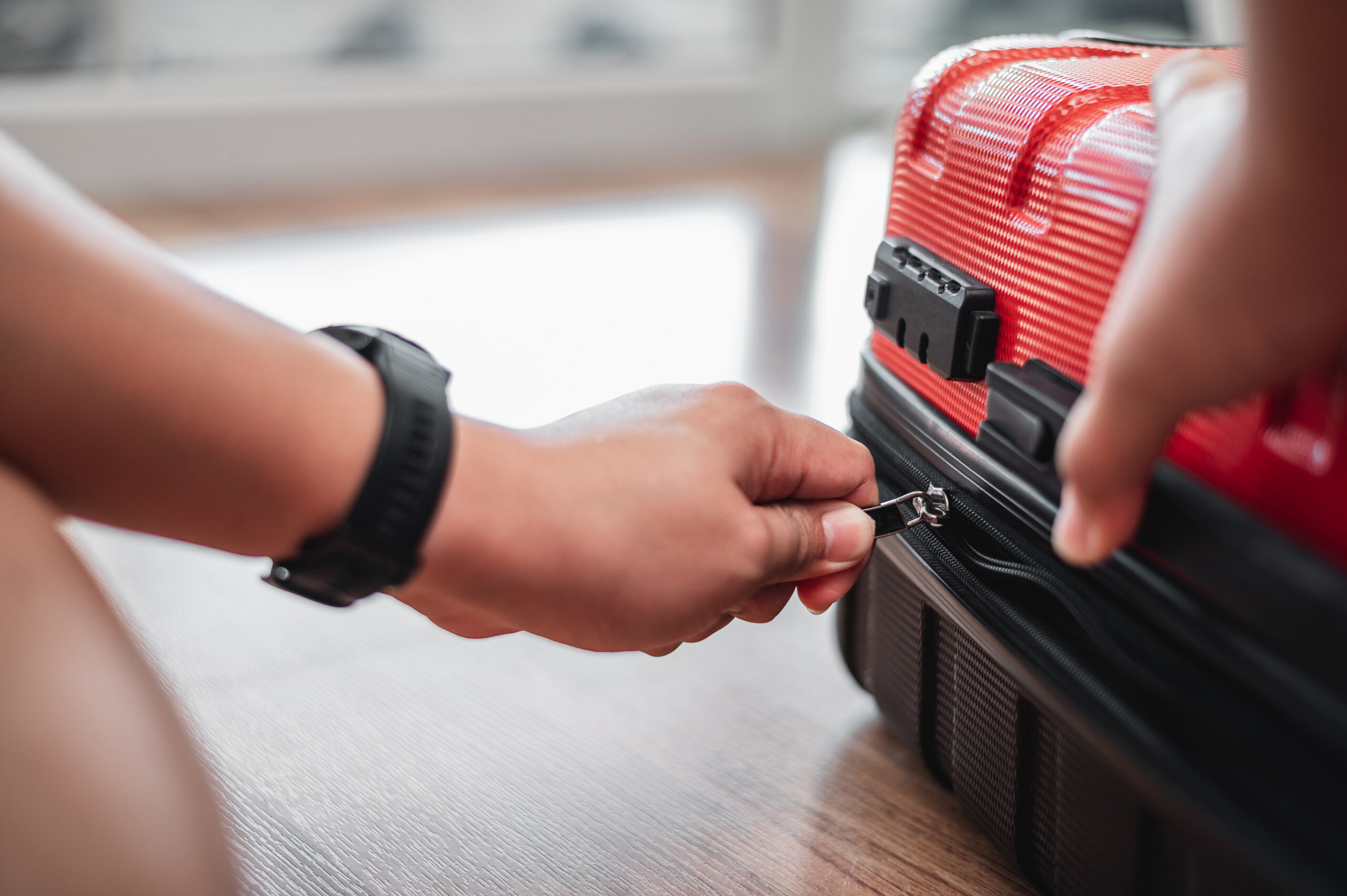 Close-up of man have finished packing and is locking them
